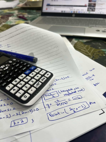 Handwritten A Level Math notes solving for repeated root and tangent point with calculator